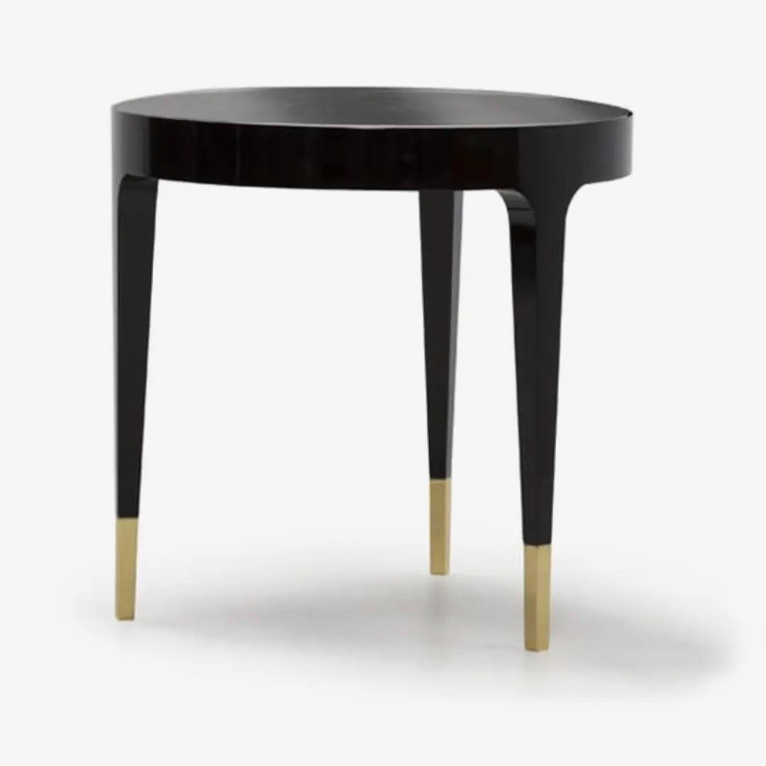 Elegant black round table with gold-tipped legs