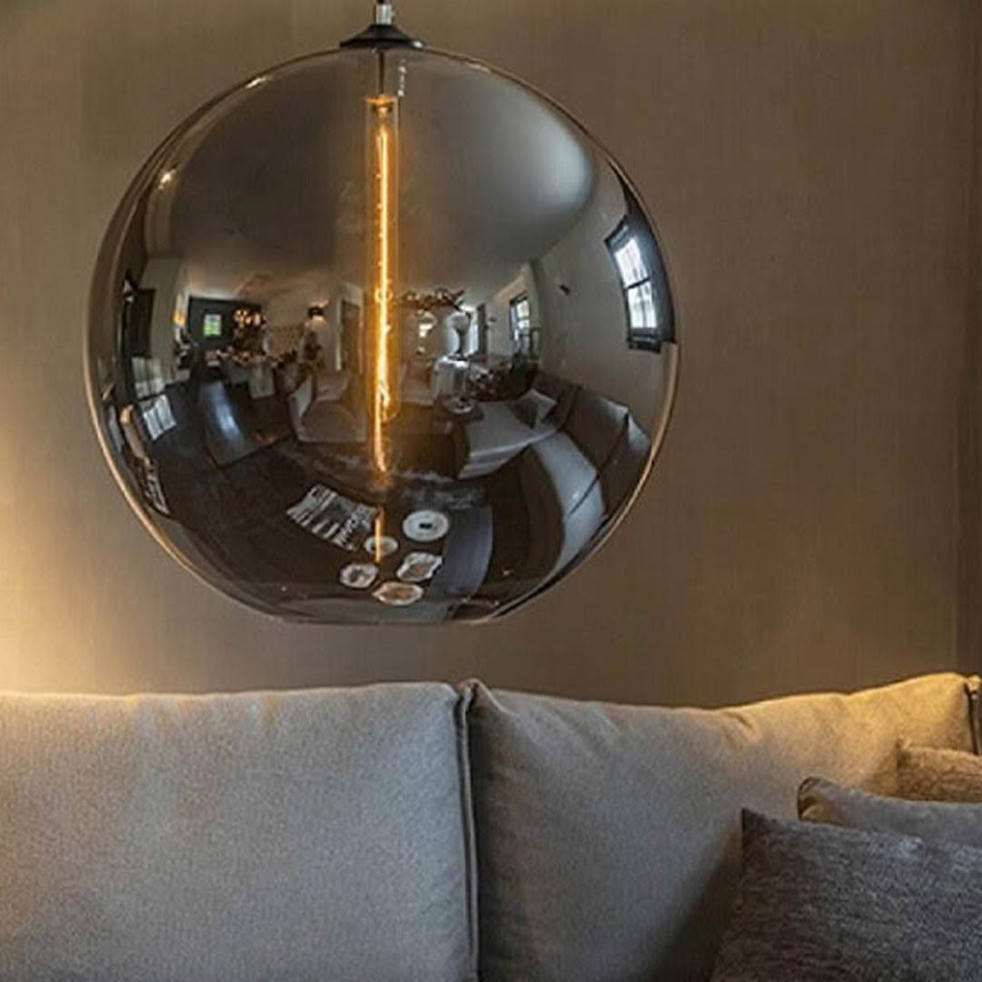 Reflective orb pendant light showing room interior