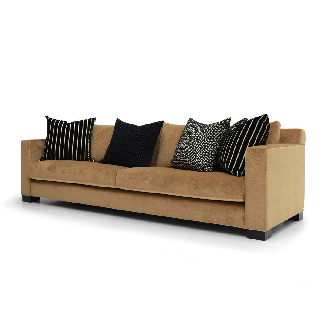 Beige sofa with assorted black and white pillows