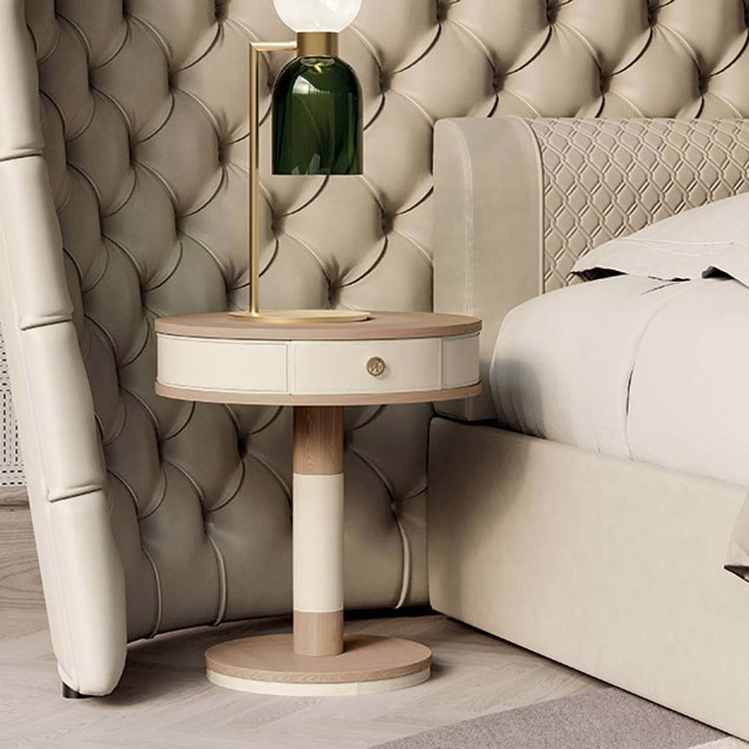 Elegant bedside setup with lamp and tufted headboard