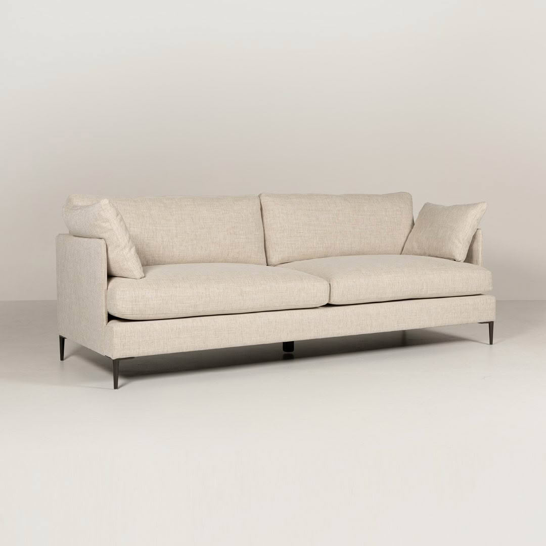 Elegant beige sofa on a neutral background