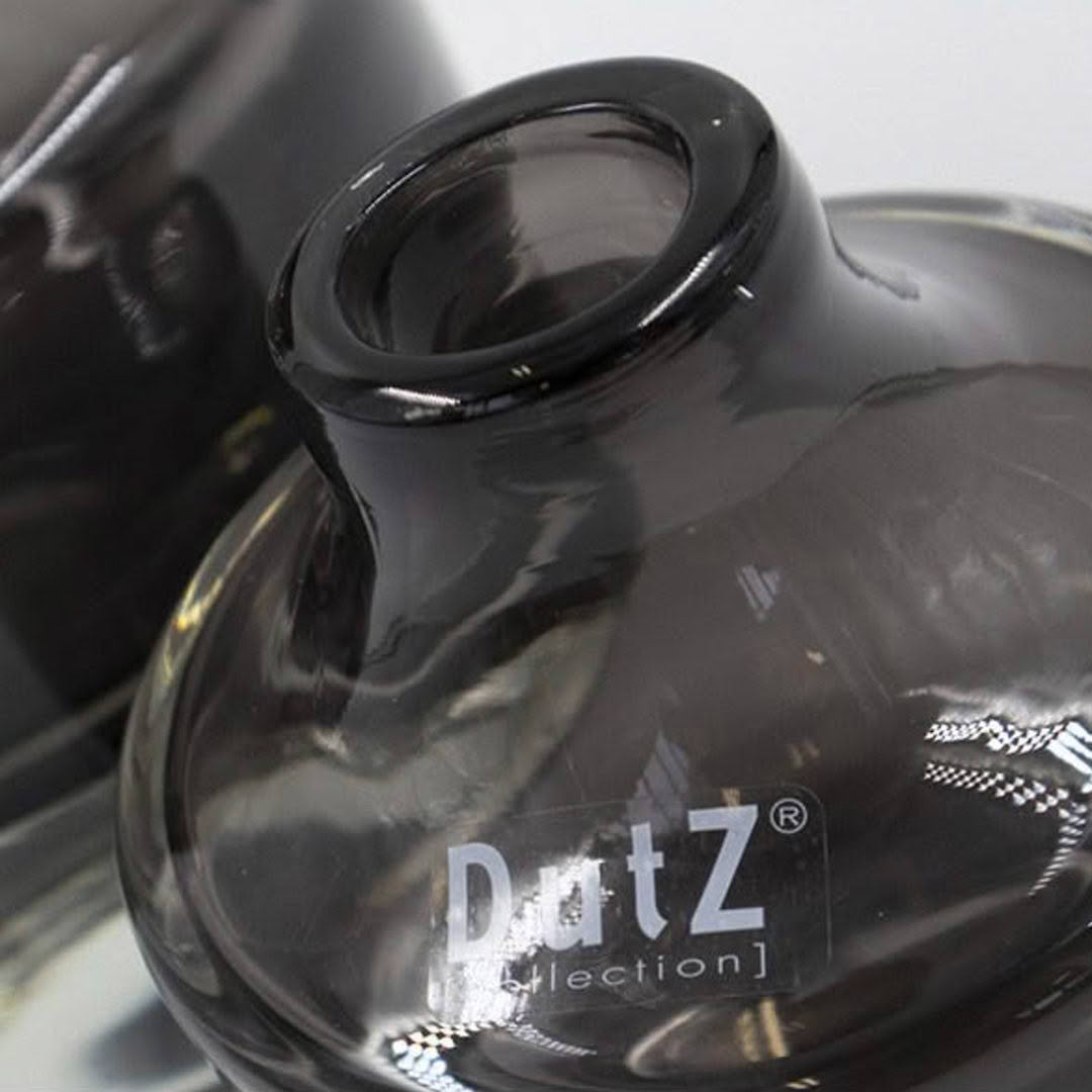 Close-up of black glass vase with Dutz logo