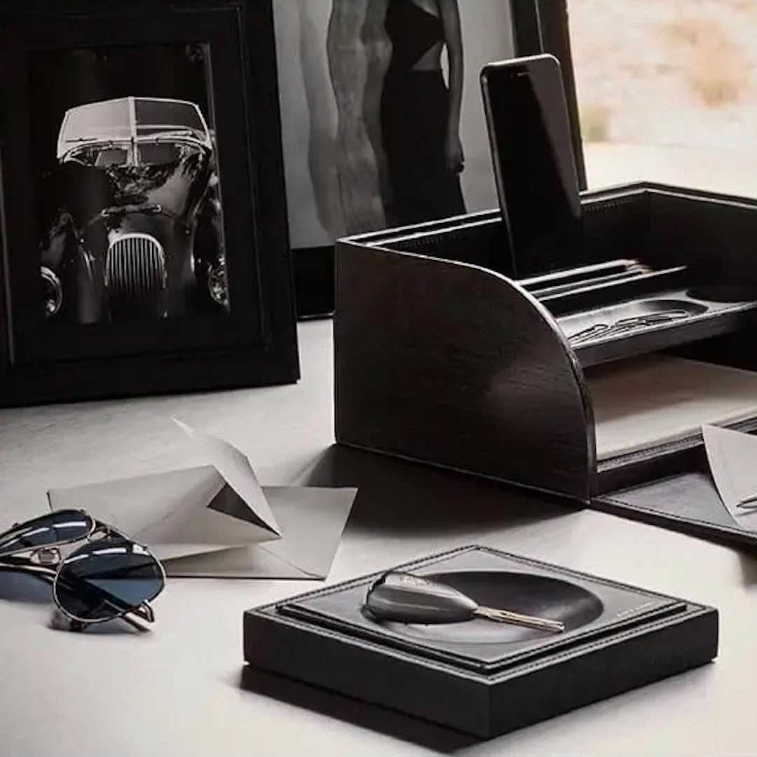 Elegant desk setup with accessories and vintage car photo