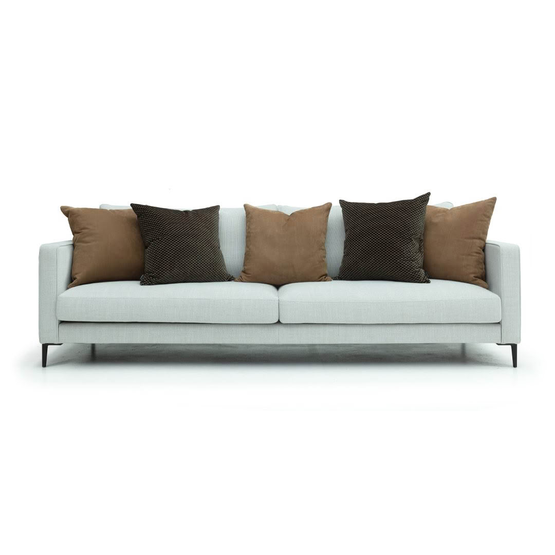 Gray sofa with brown and black cushions on white