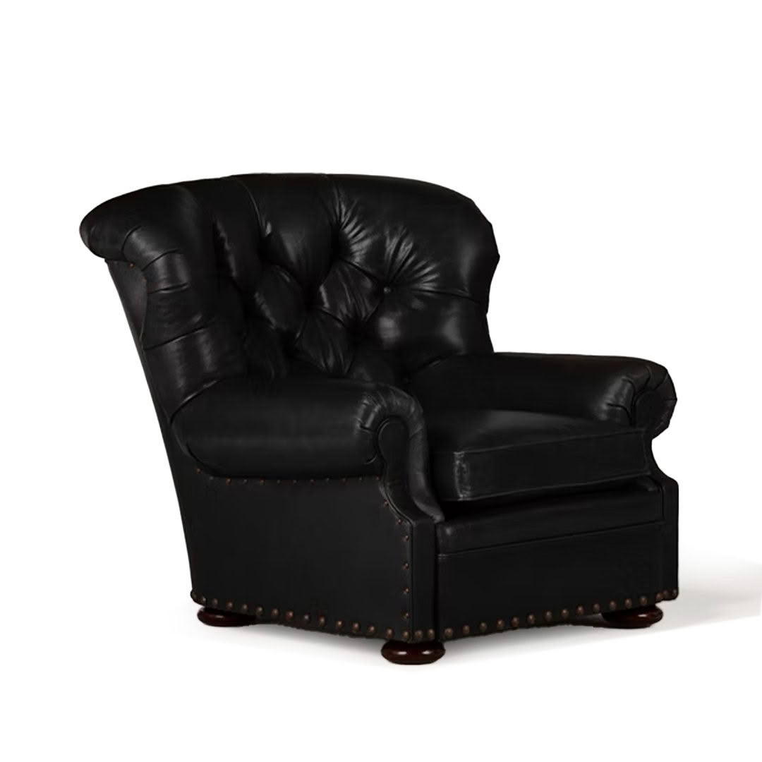 Elegant black leather armchair with brass studs