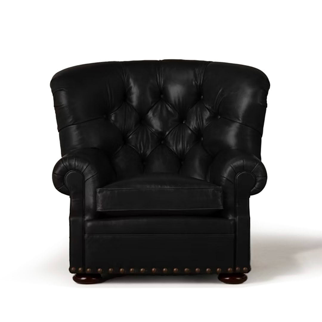 Elegant black leather tufted armchair with brass studs