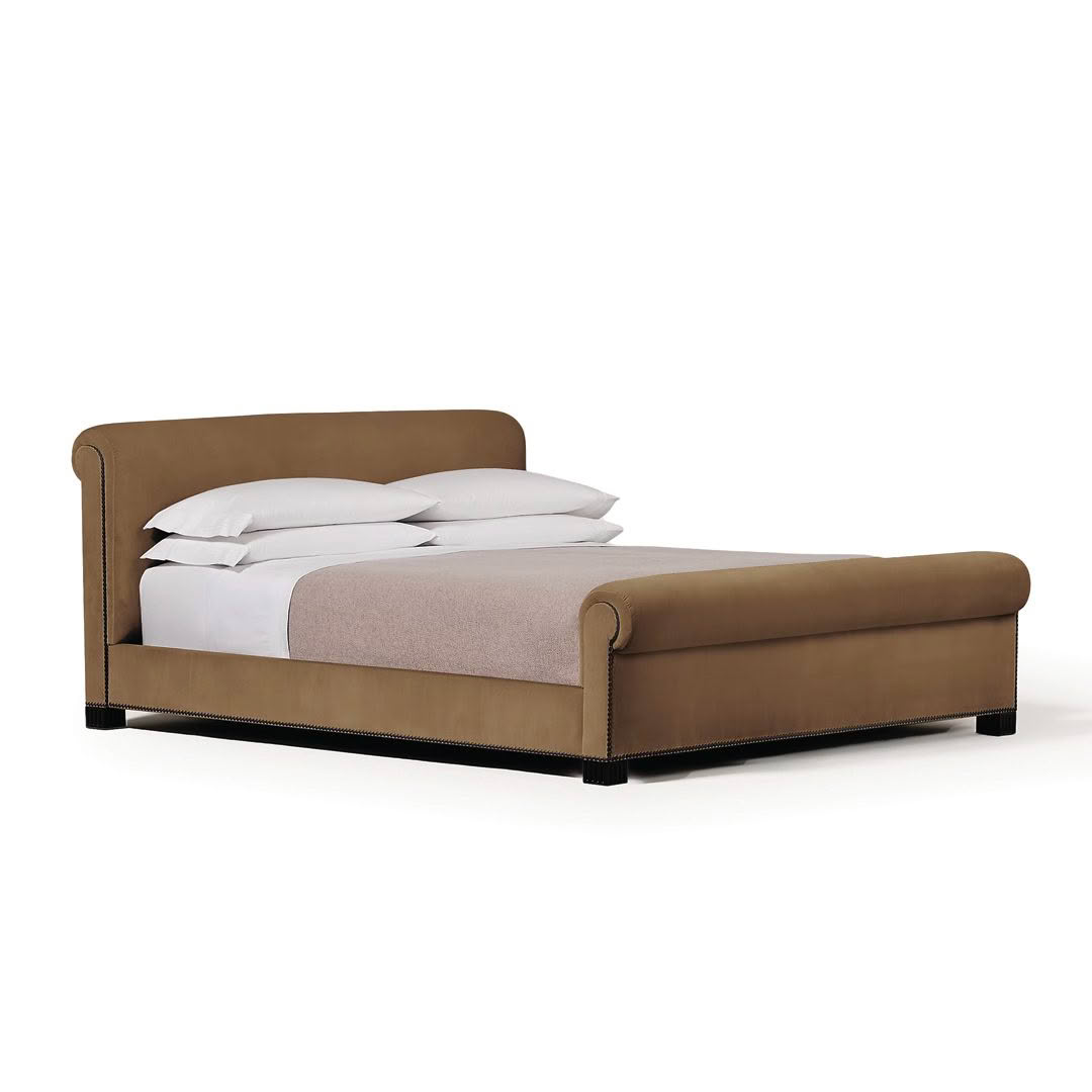 Elegant brown upholstered bed with white bedding