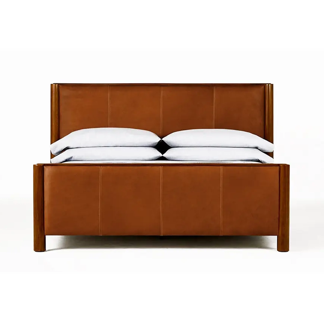 Modern brown leather bed with white pillows