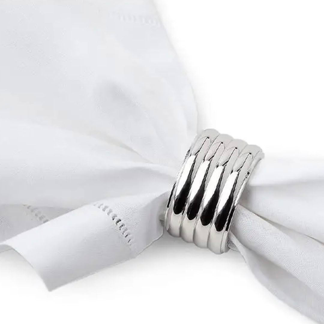 Silver napkin ring on white fabric