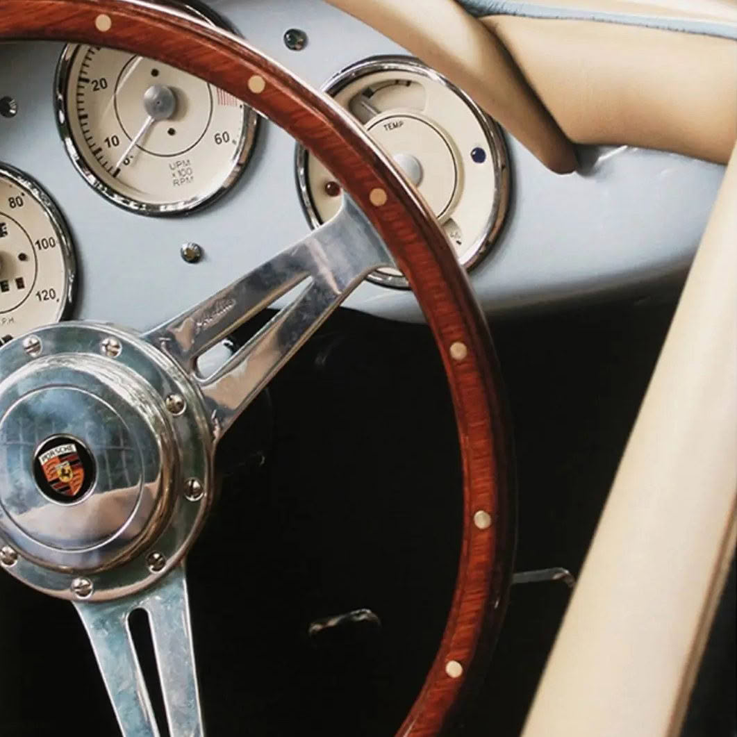 Vintage Porsche dashboard and wooden steering wheel