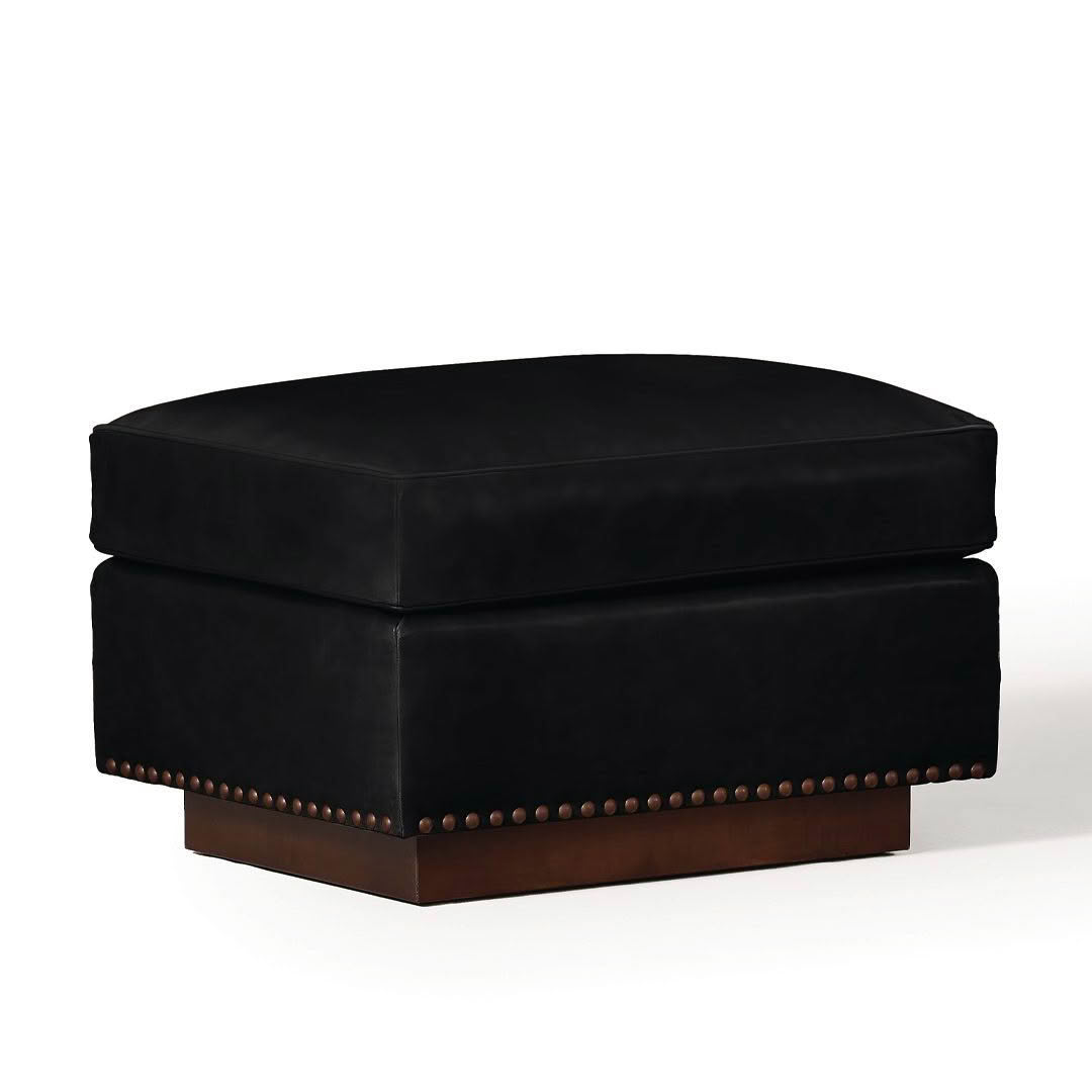 Black velvet ottoman with brass nailhead details