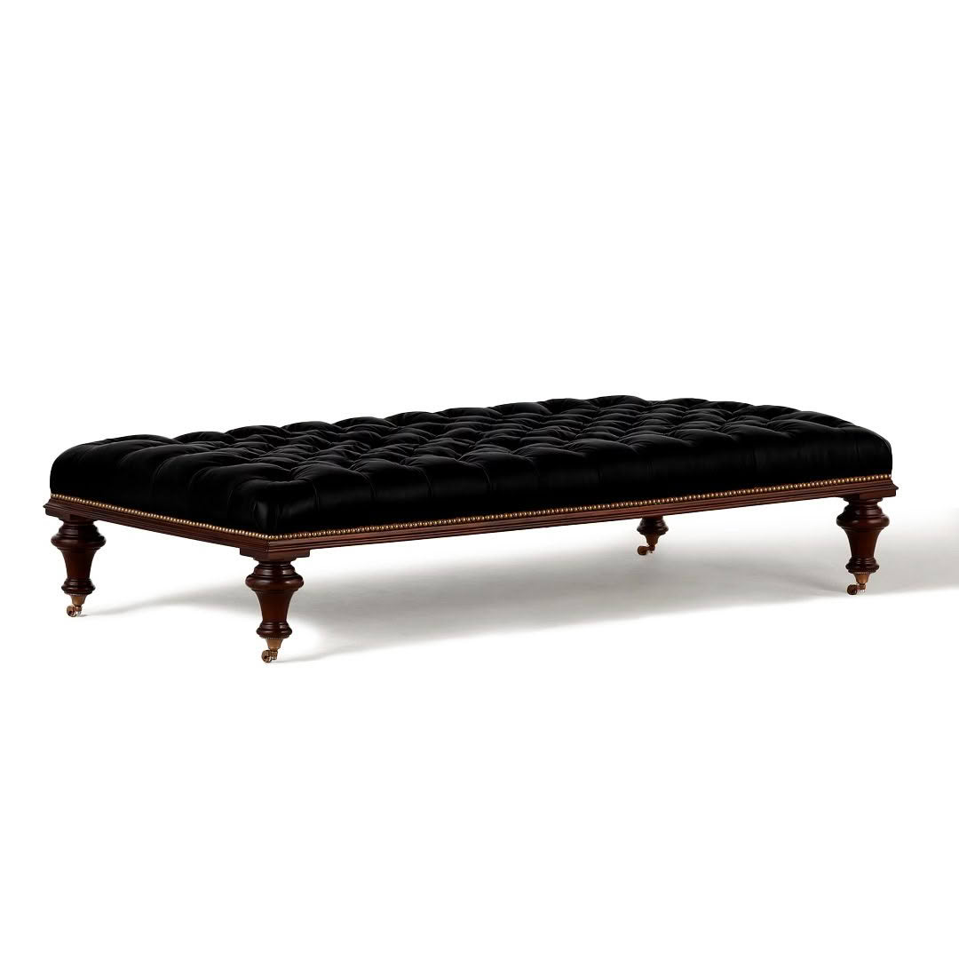 Elegant black tufted ottoman with wooden legs