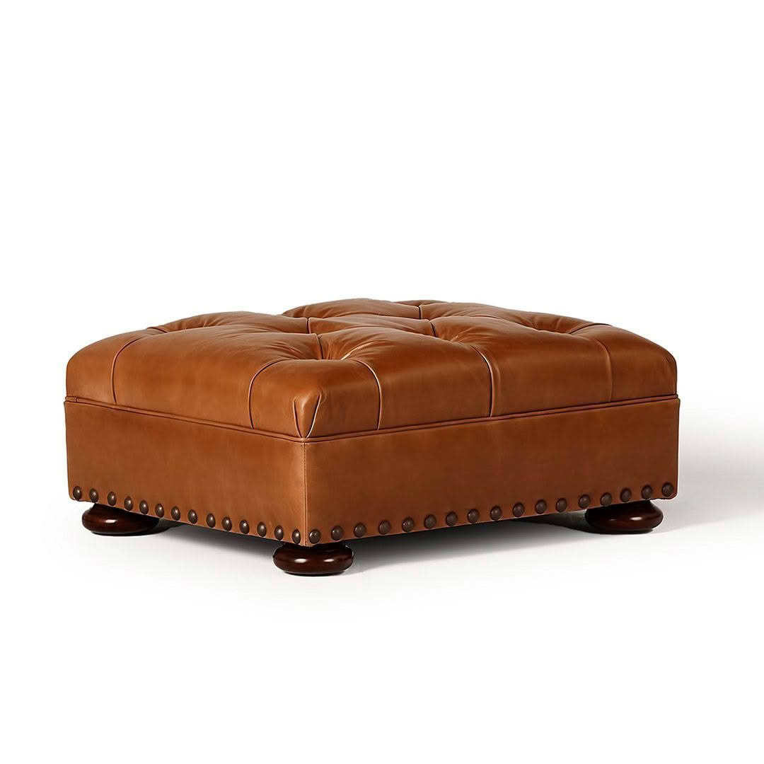 Brown leather tufted ottoman with nailhead trim