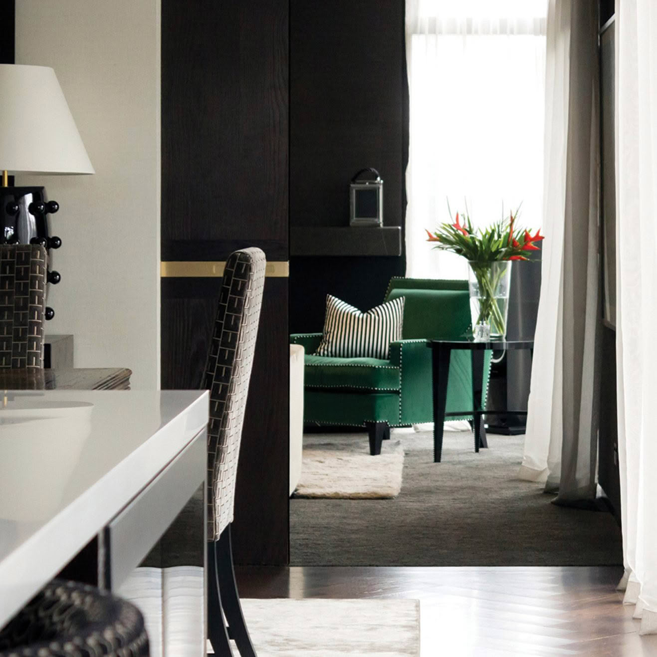 Elegant interior with green armchair and striped cushion