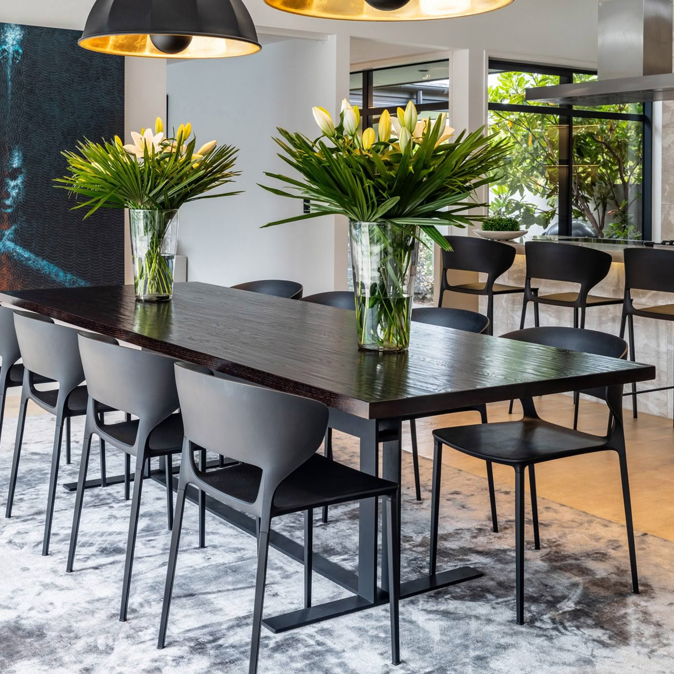 Modern dining area with floral centerpieces and designer furniture