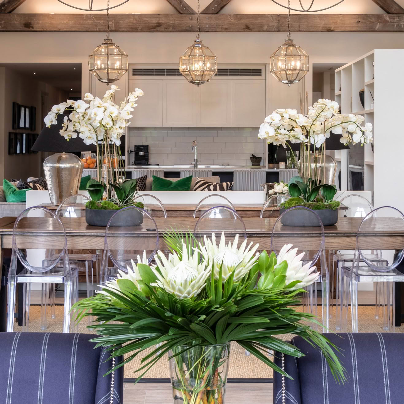 Elegant dining room with modern kitchen in the background