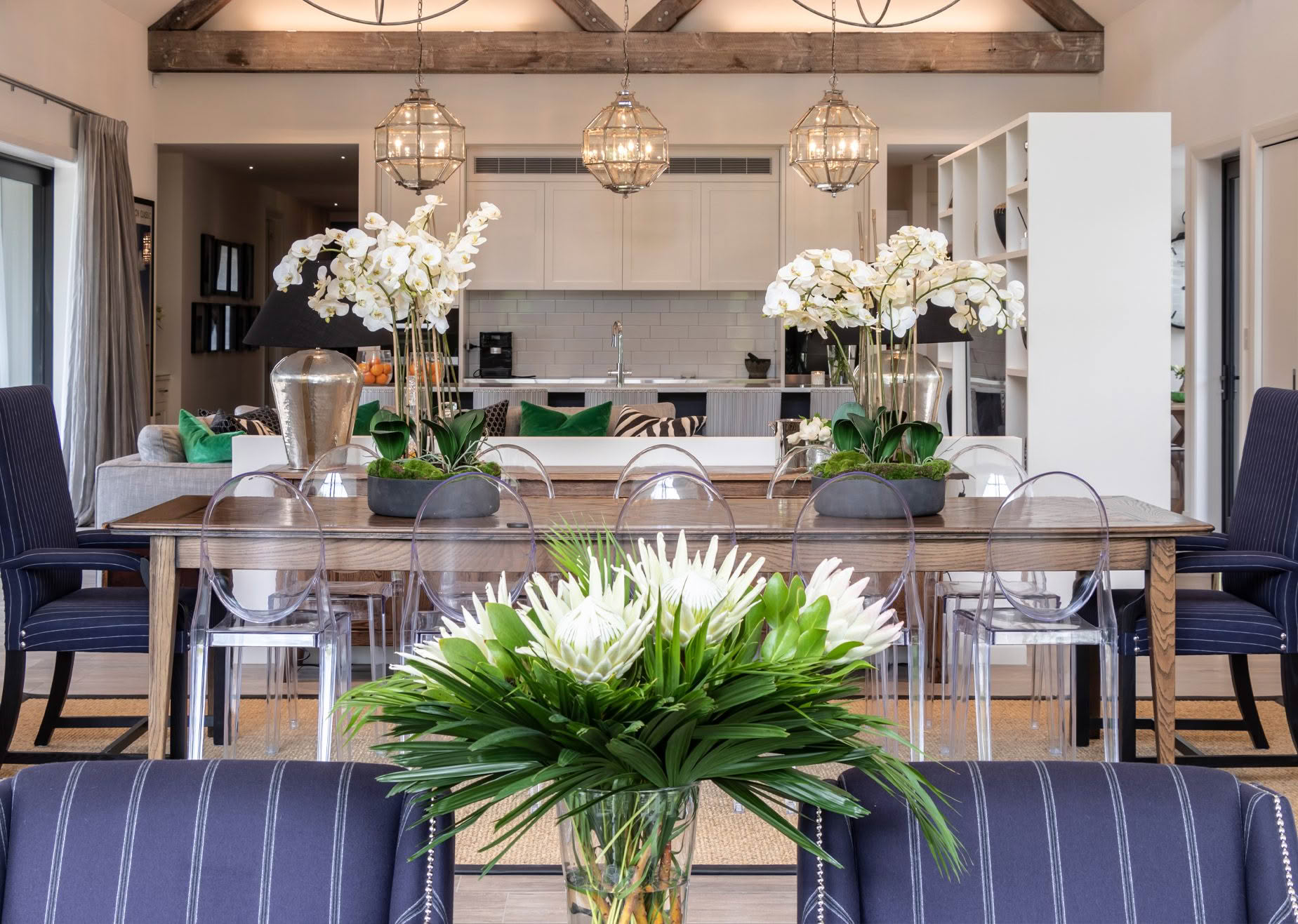 Elegant dining room with modern kitchen in background