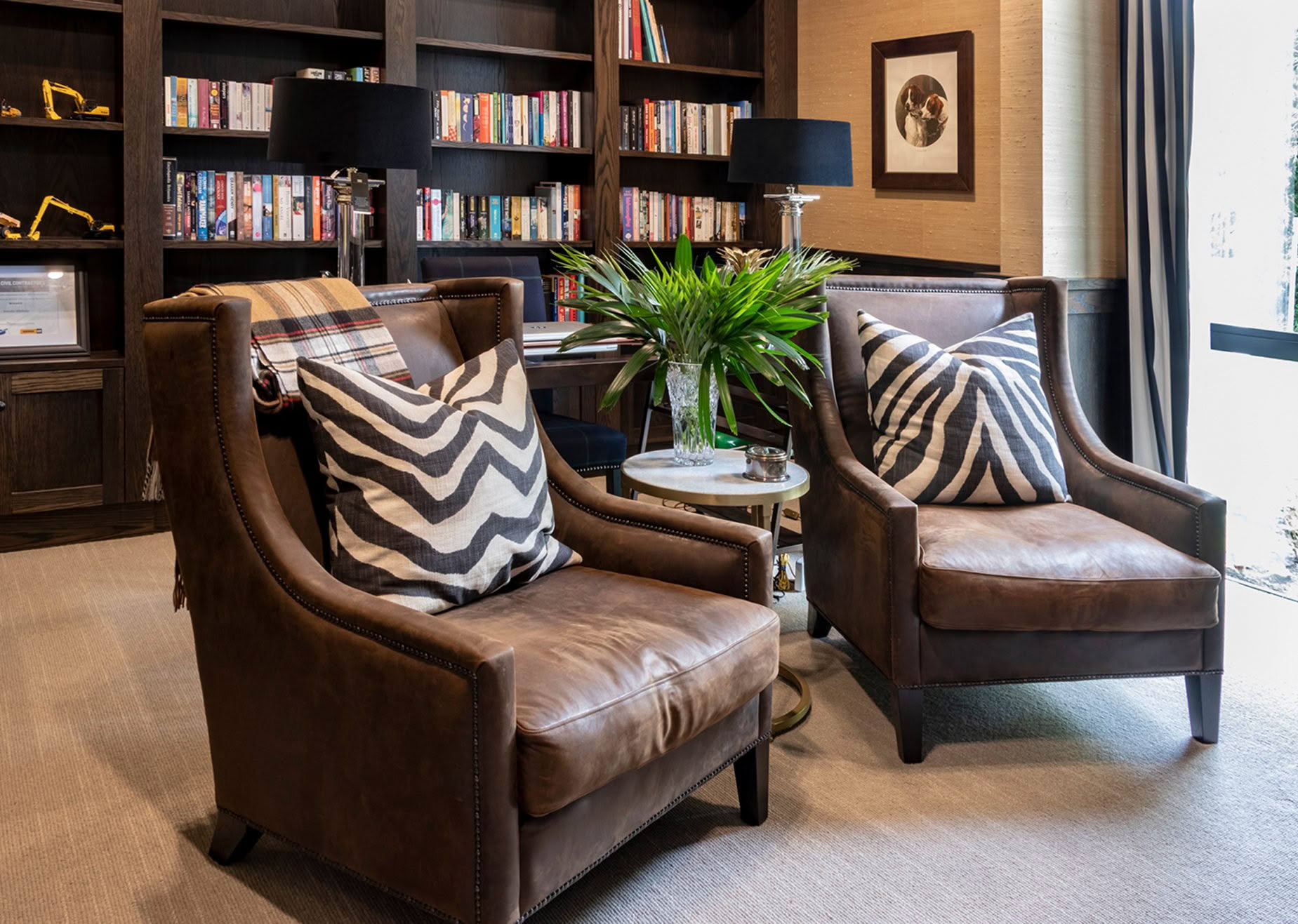 Elegant home study with leather chairs and bookshelves