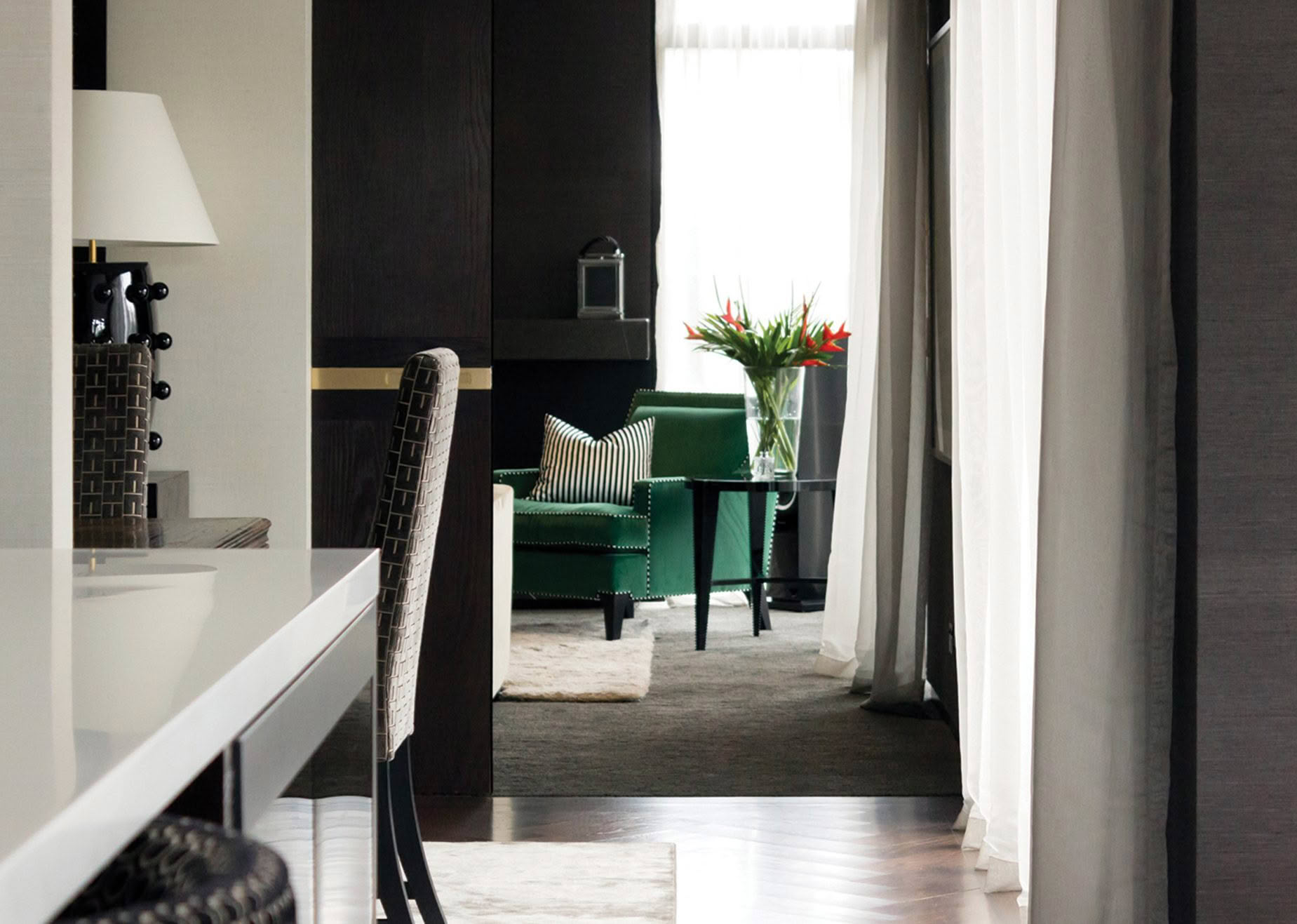 Elegant interior with green chair and striped pillow