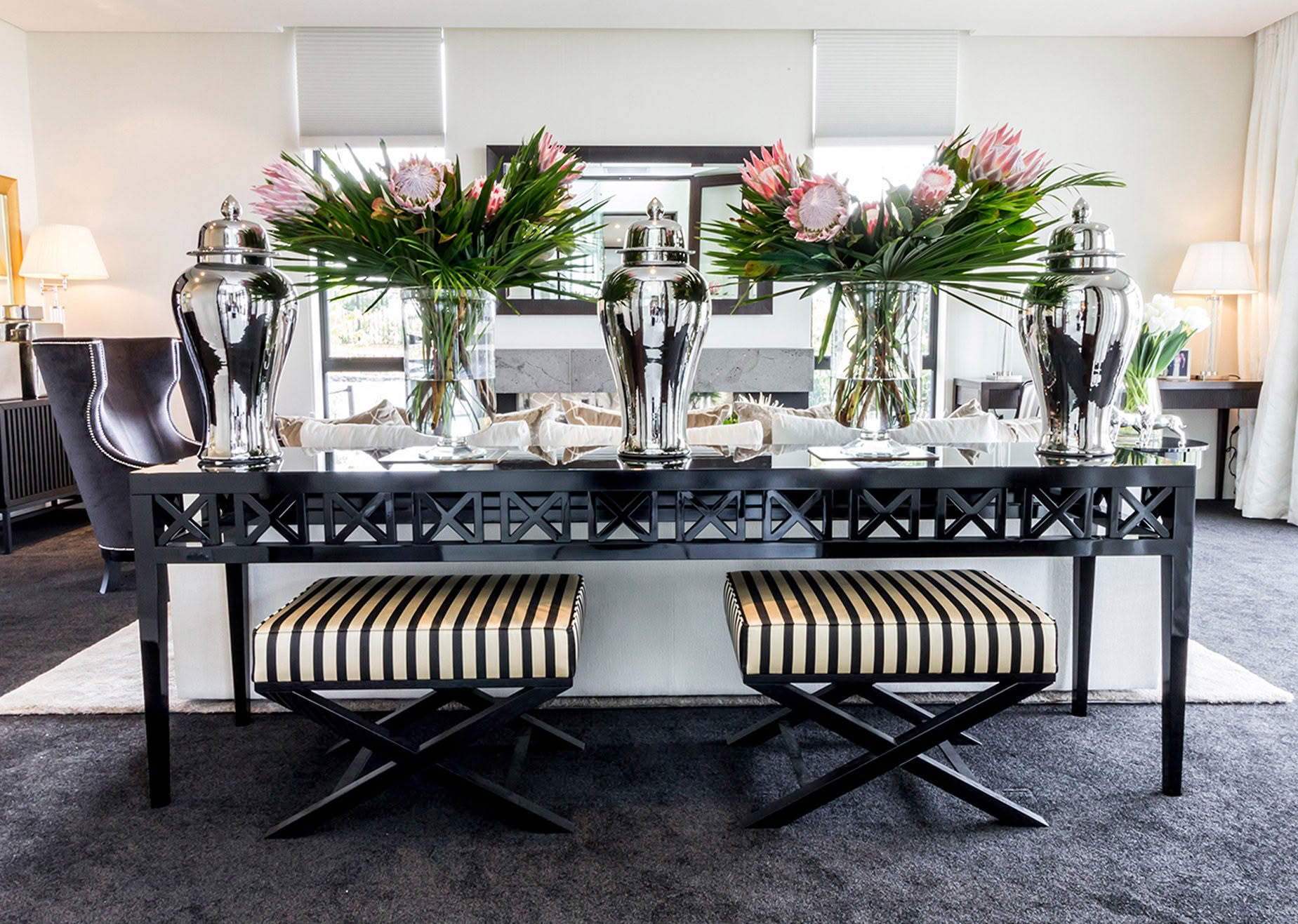 Elegant dining room with floral centerpieces and mirrored decor