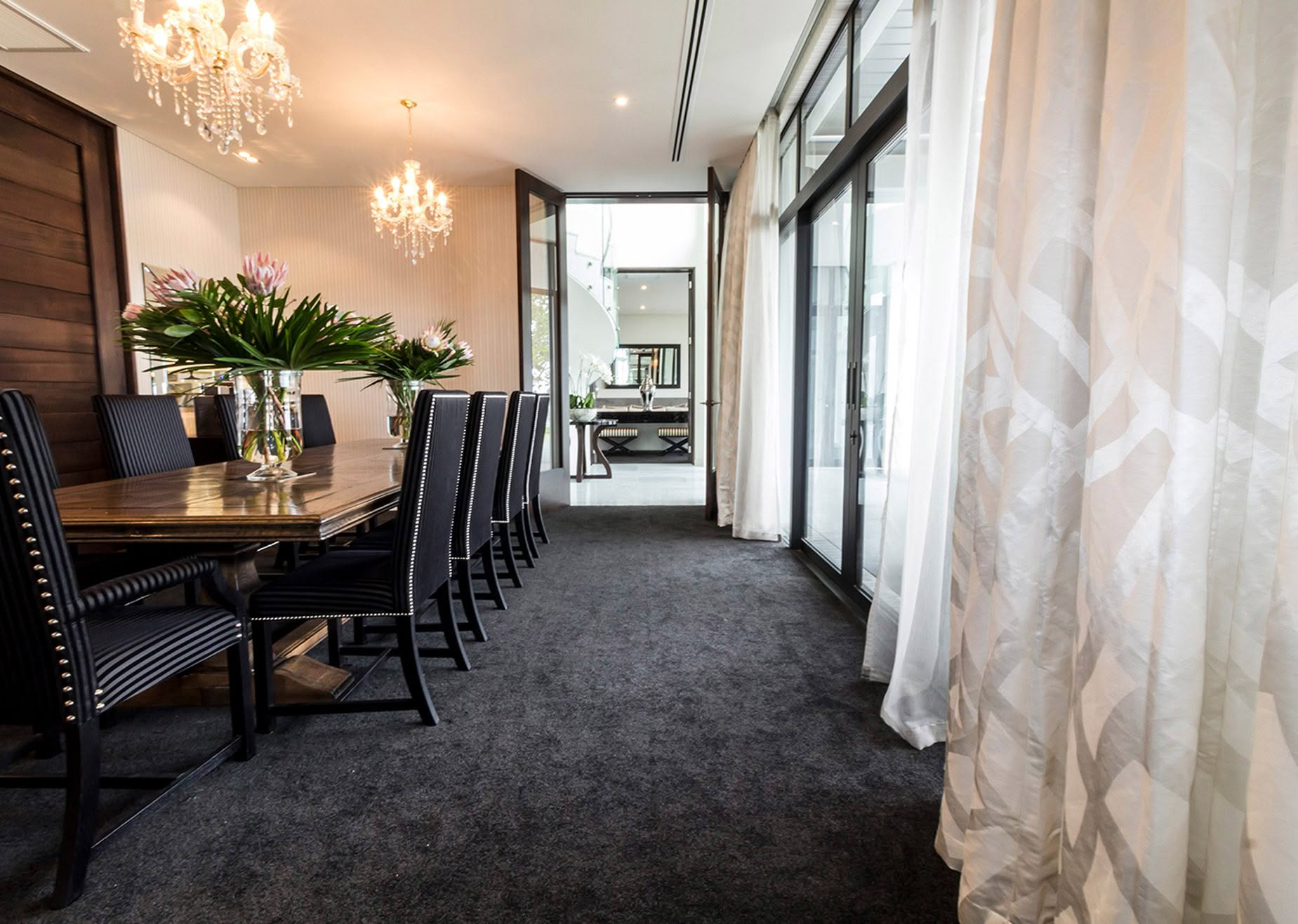 Elegant dining room with chandeliers and modern decor