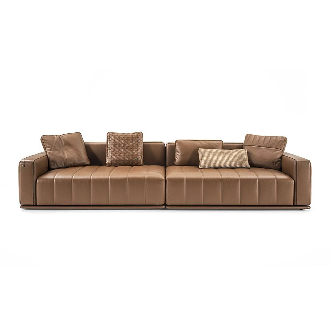 Modern brown leather sofa with cushions