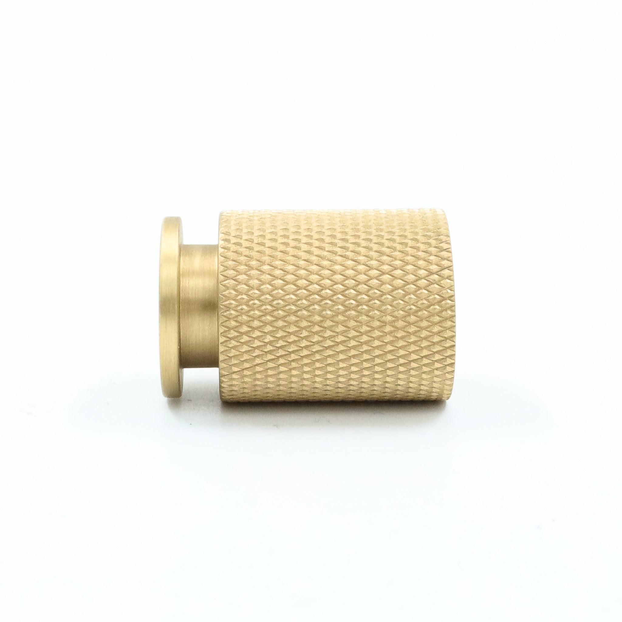 Textured golden knob on white background