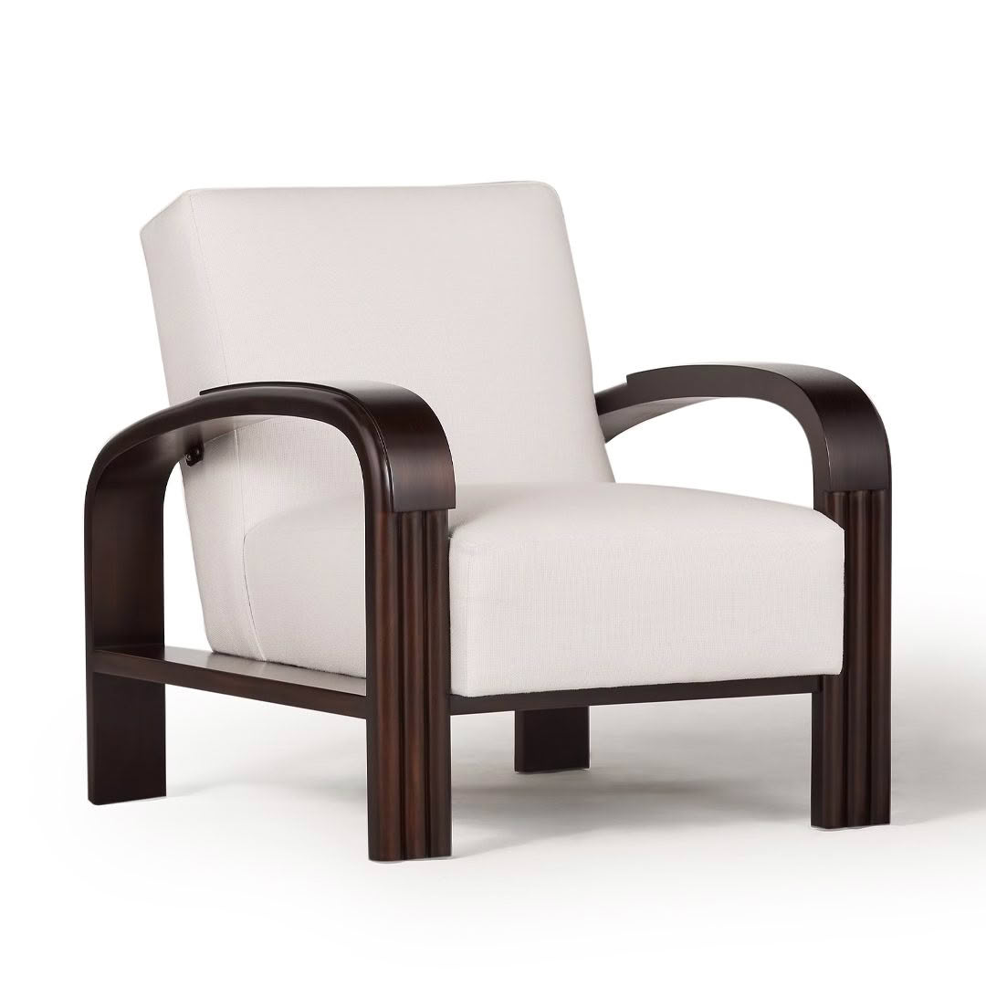 Modern cream upholstered chair with dark wooden arms