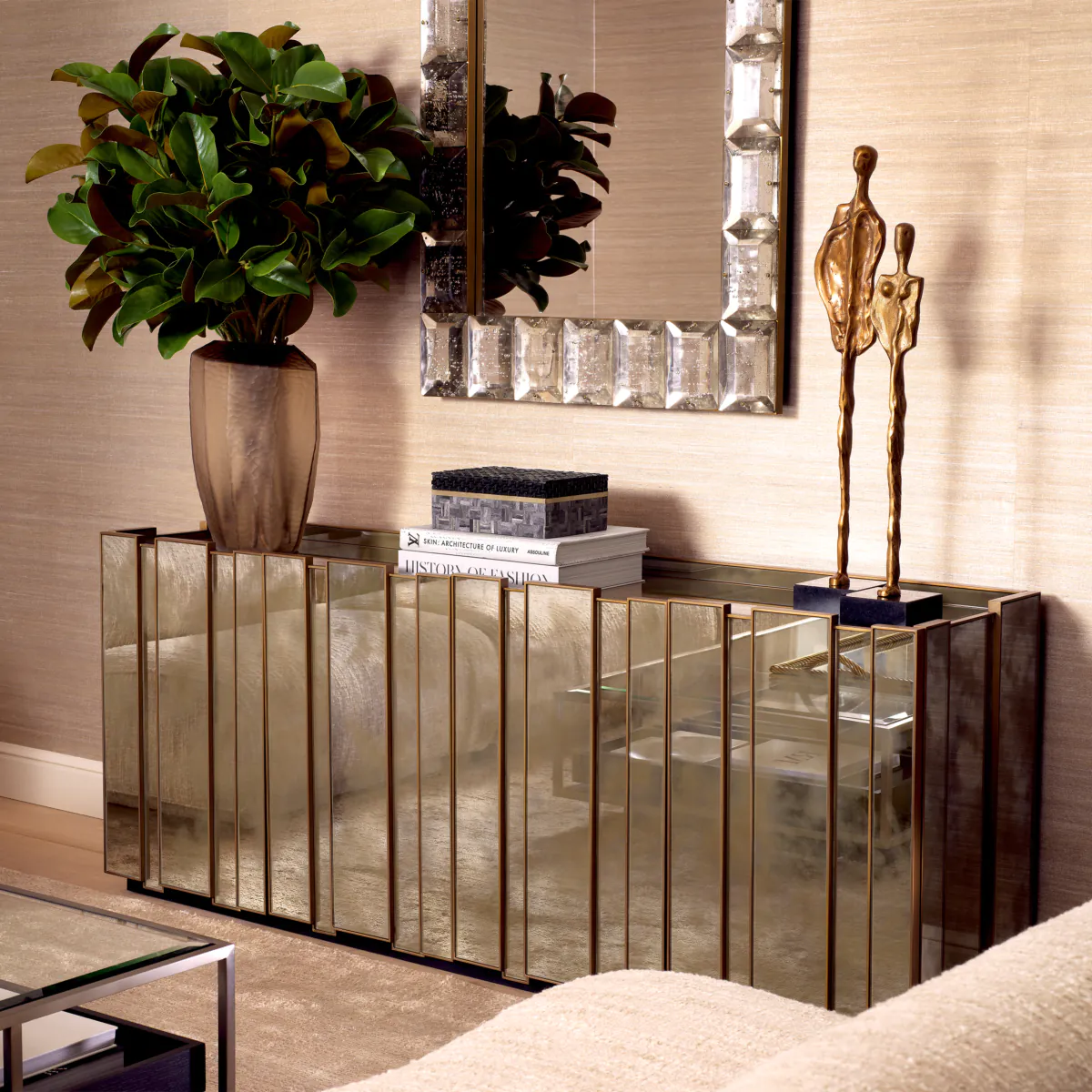 Elegant mirrored console cabinet with sculpture and plants