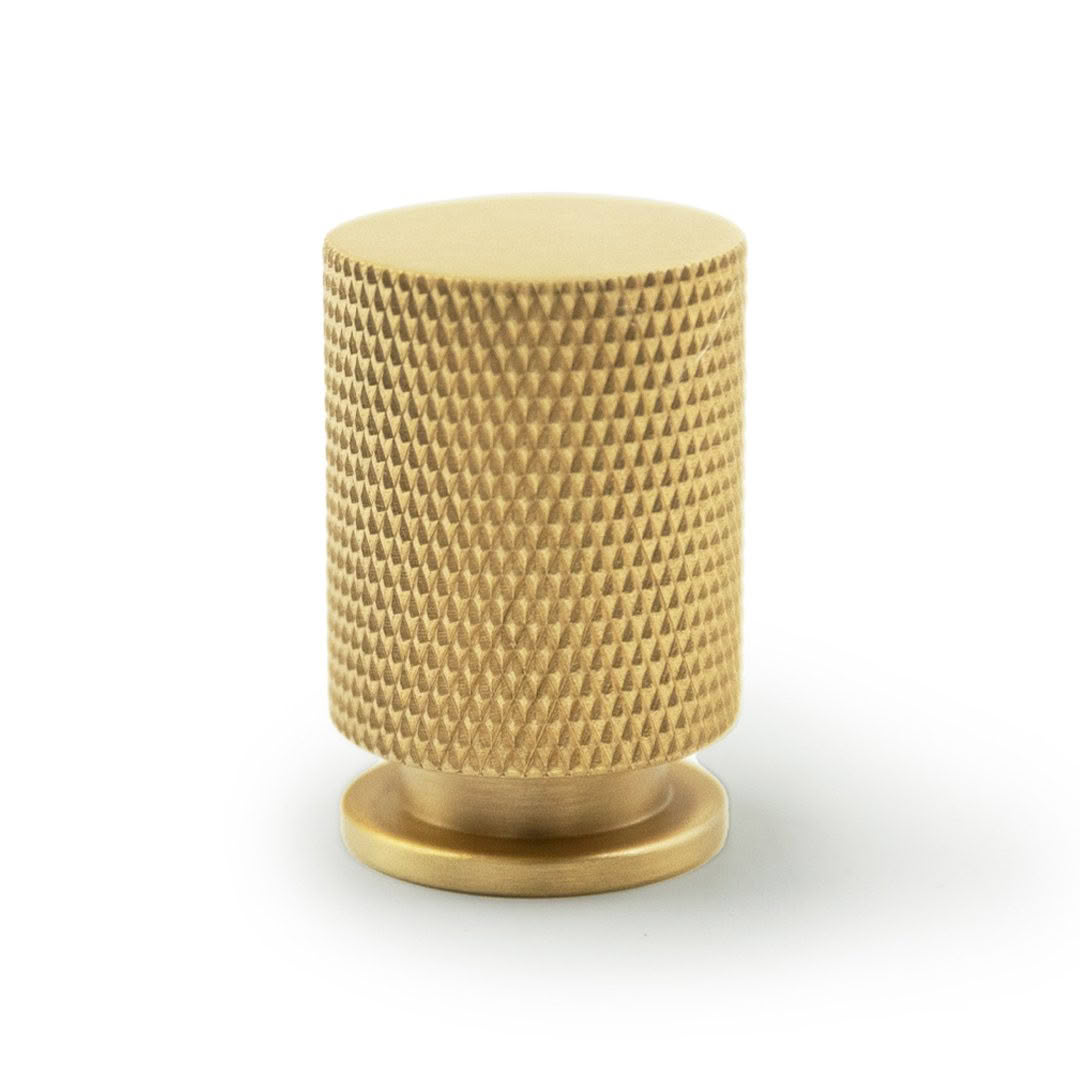 Textured golden knob on white background