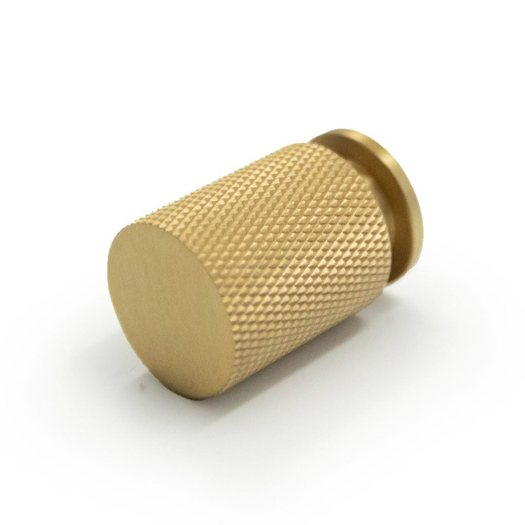 Gold knurled knob on white background