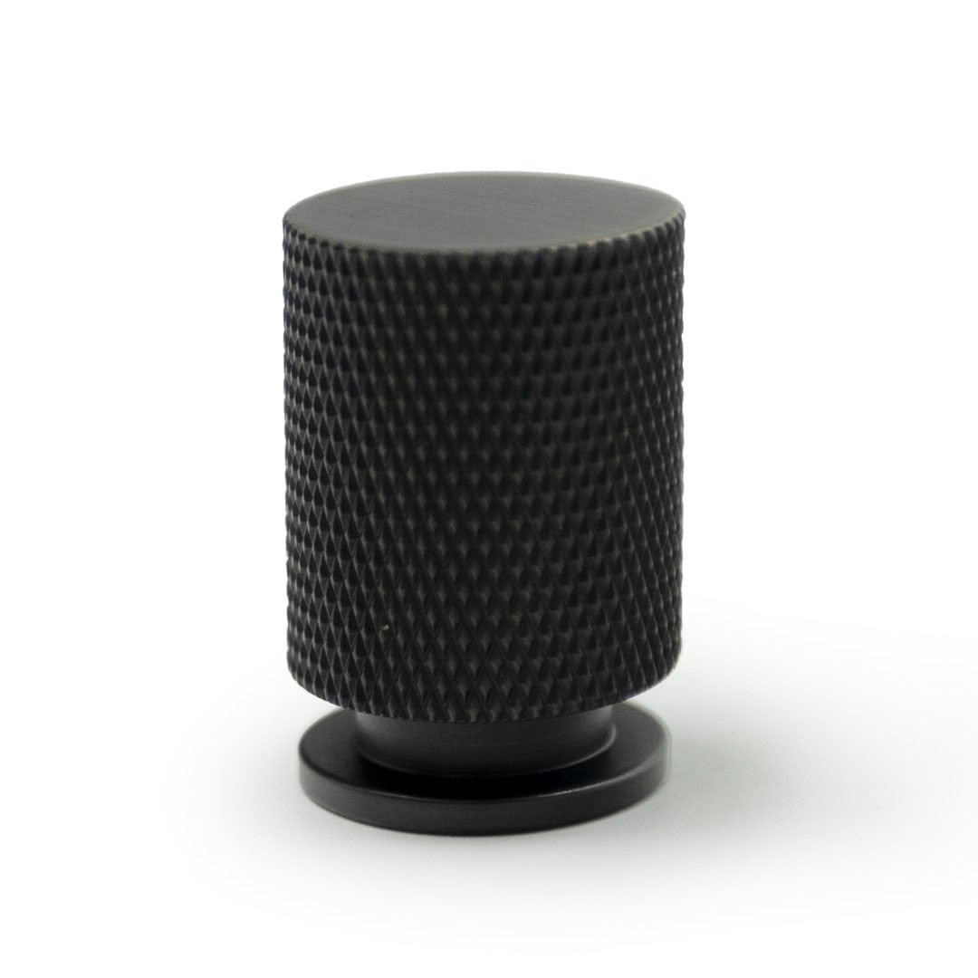 Black cylindrical textured microphone on white background