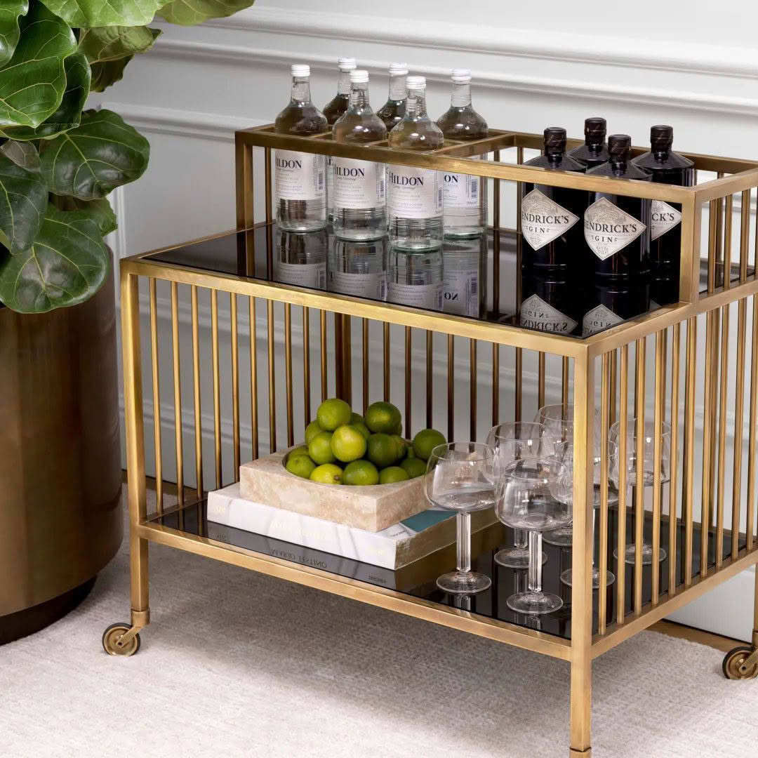 Elegant bar cart with drinks, glasses, and fresh limes