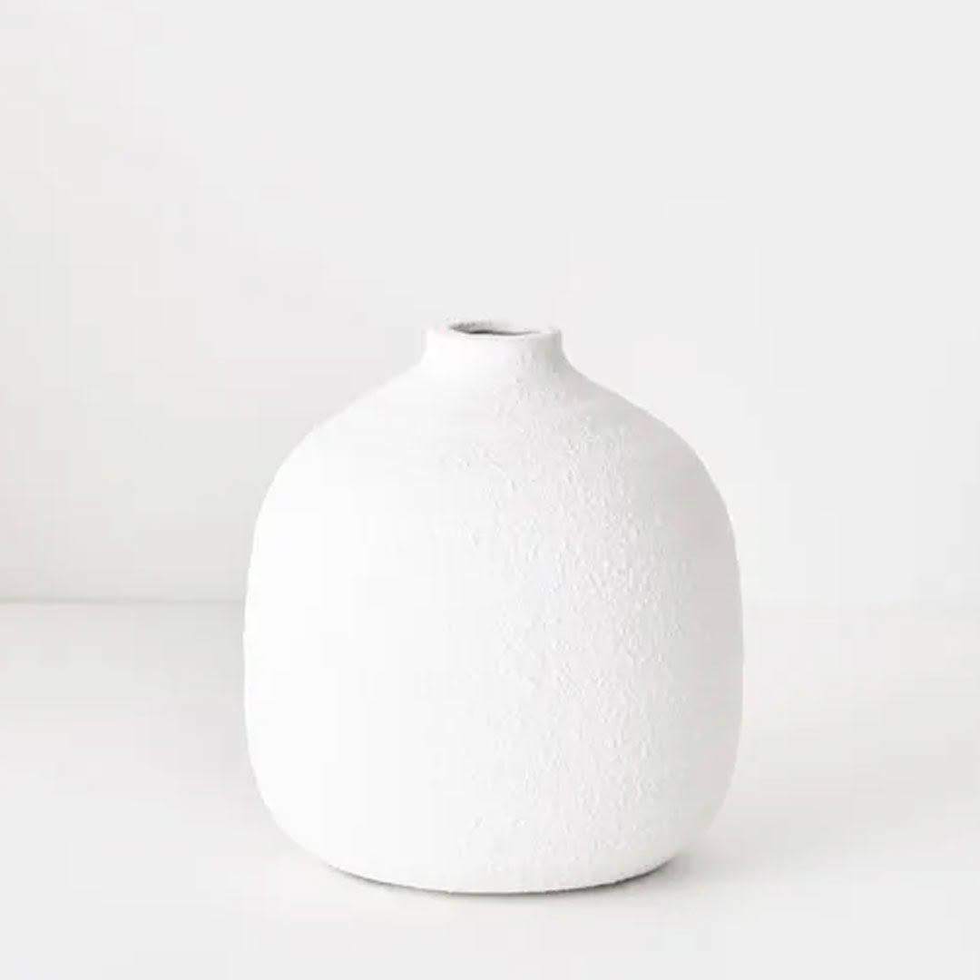 Minimalist white ceramic vase on light background