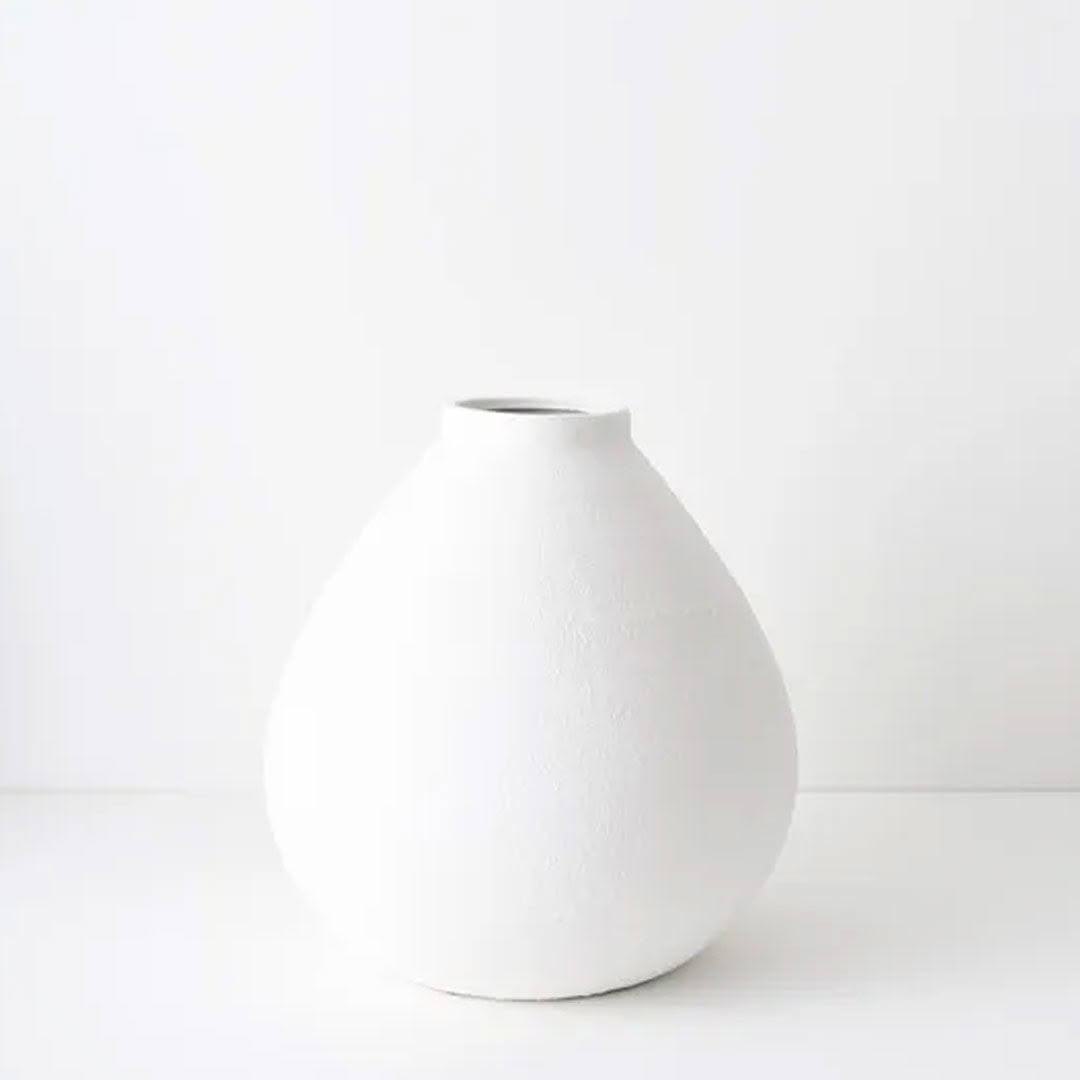 Minimalist white ceramic vase on a white background