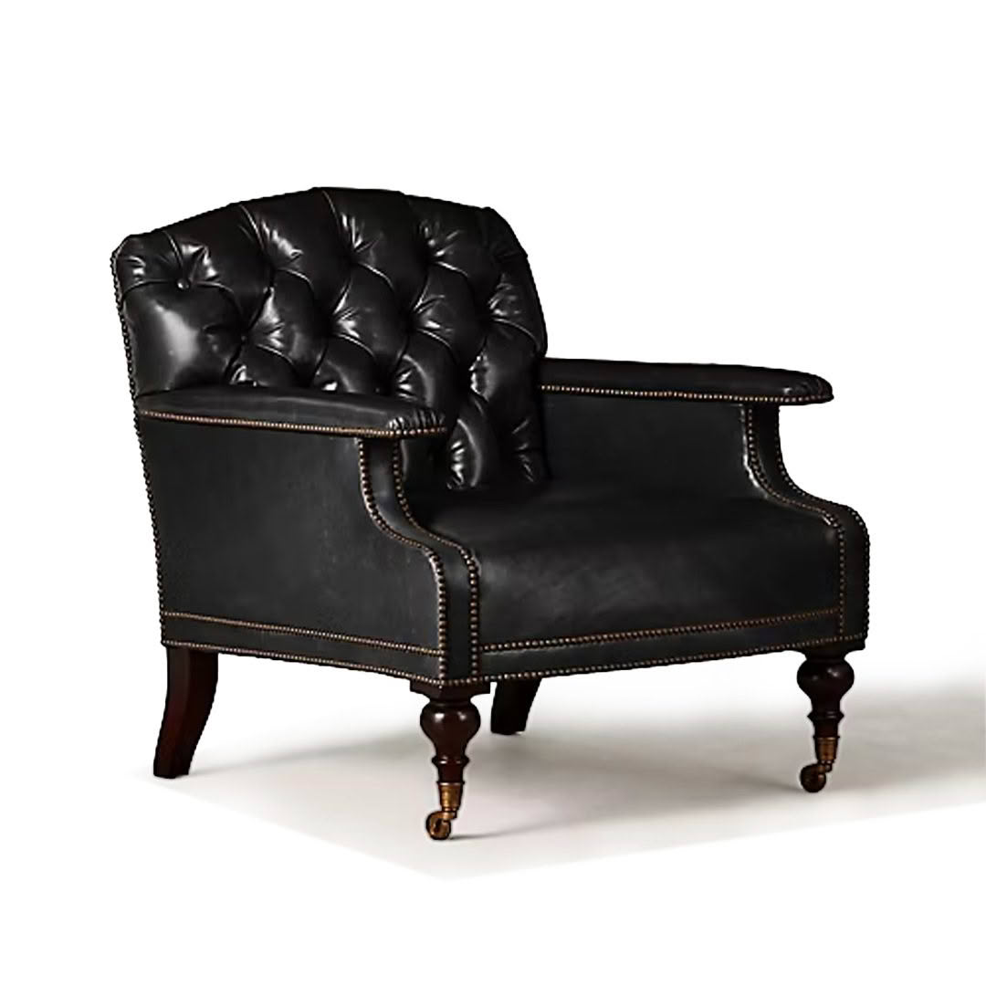 Elegant black leather tufted armchair with wooden legs