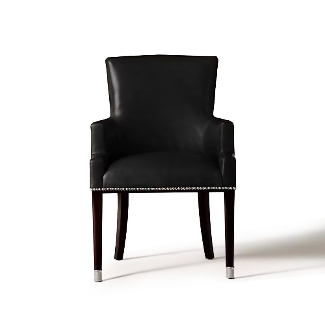 Black leather chair with wooden legs and silver studs