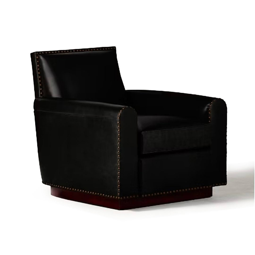 Elegant black leather armchair with brass studs