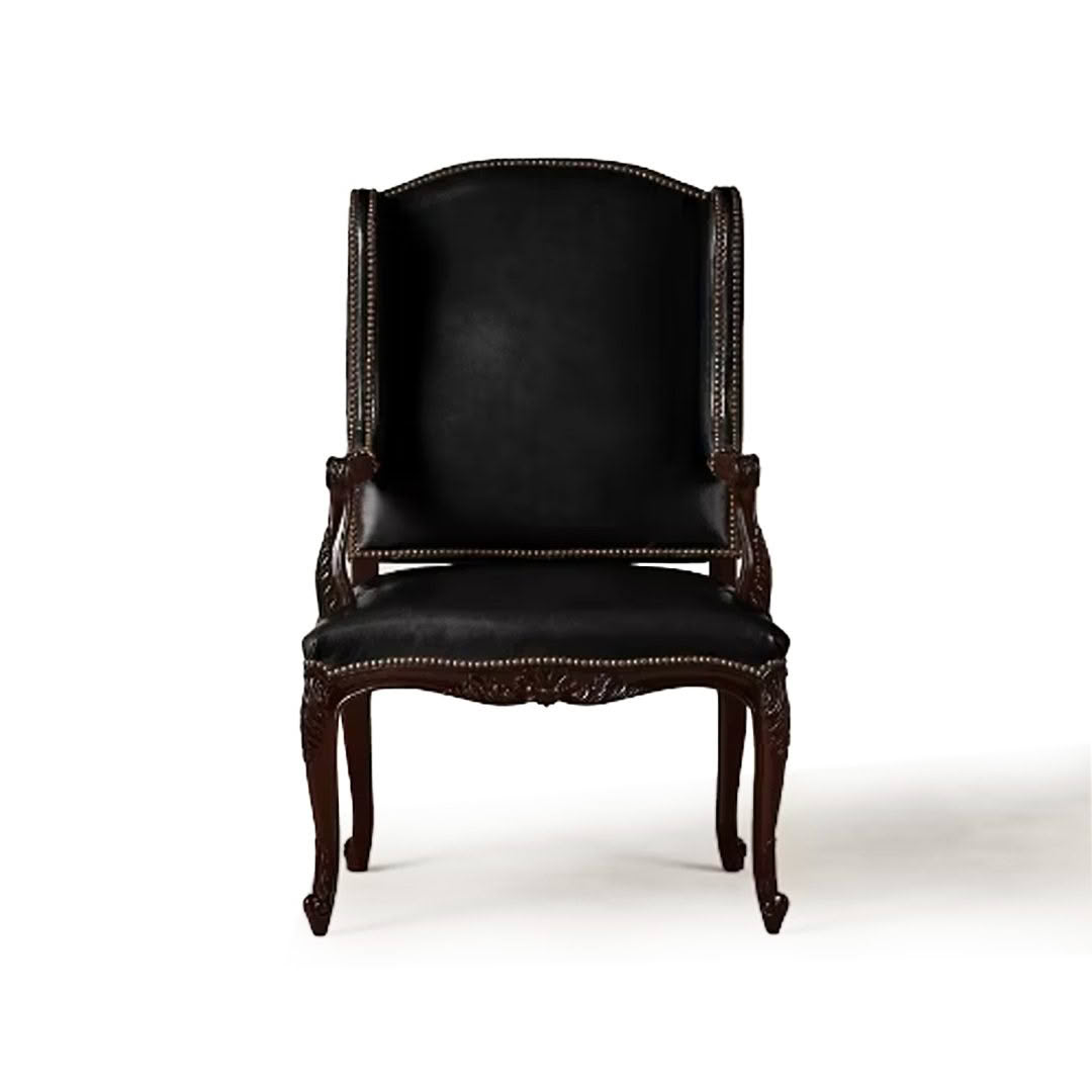 Elegant black leather antique armchair with intricate carvings