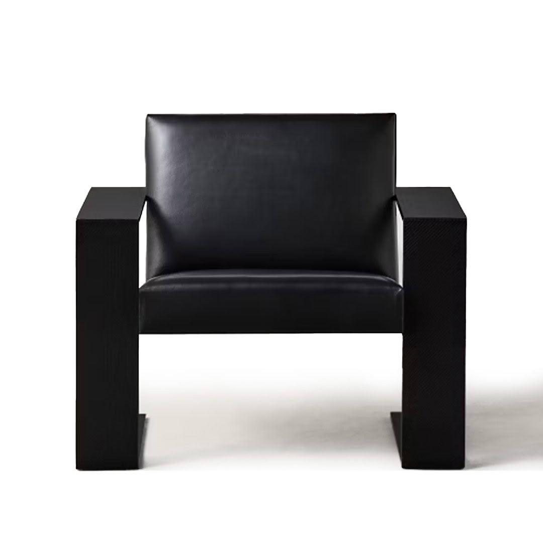 Modern black leather armchair on white background