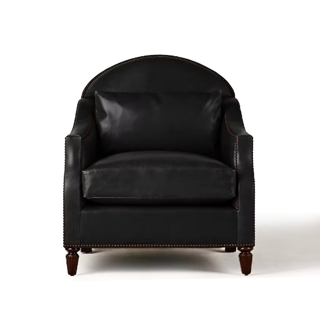Elegant black leather armchair with wooden legs