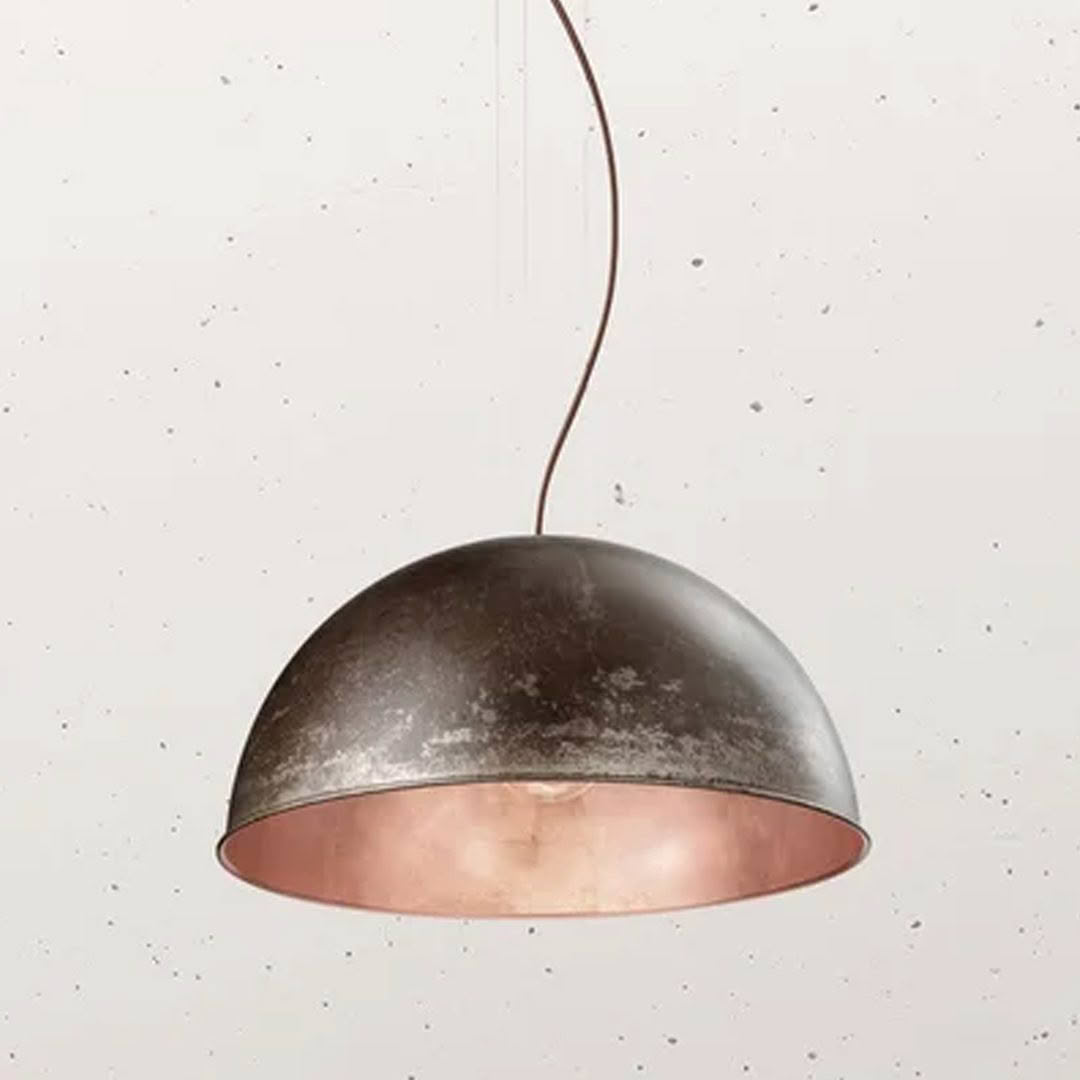 Vintage copper-hued pendant light against speckled backdrop