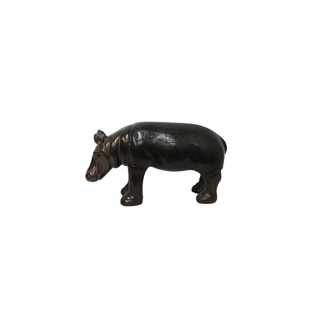 Small black hippopotamus figurine on white background