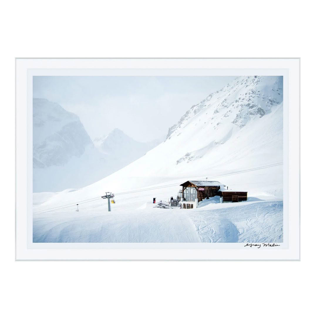 Snowy mountain ski resort with chairlift and cabin