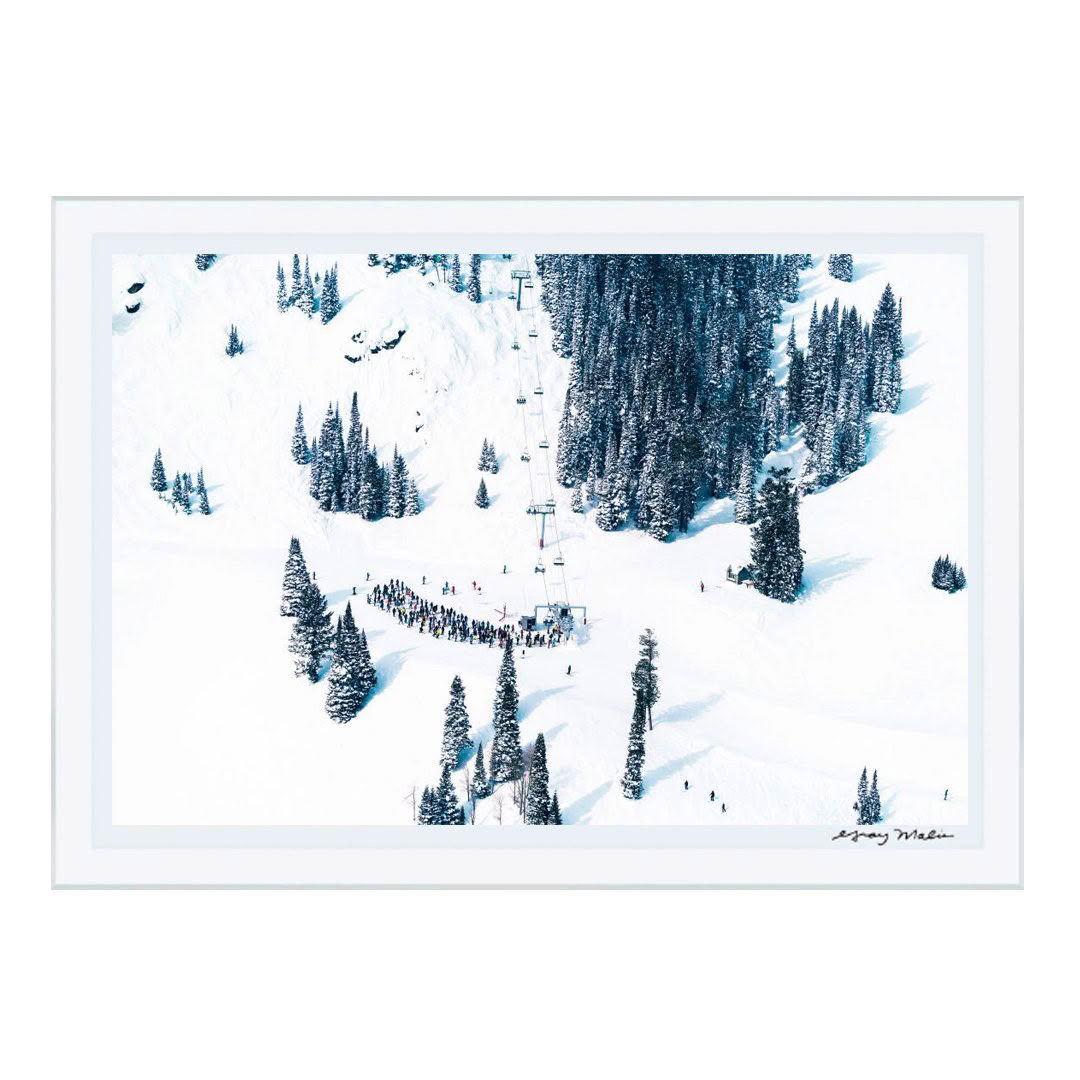 Snowy ski slope with trees and lift queue