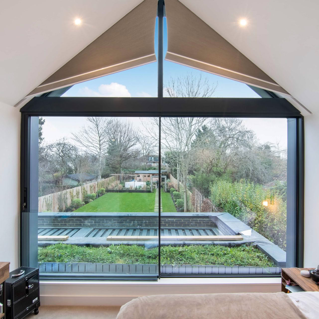 Interior view through large window to lush backyard