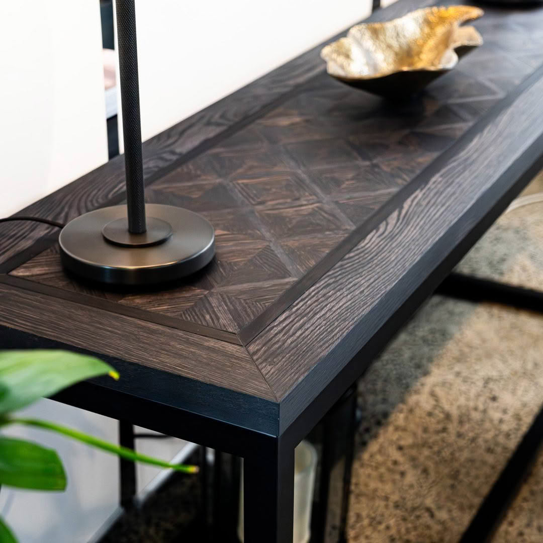 Elegant dark wood console table with decorative golden bowl