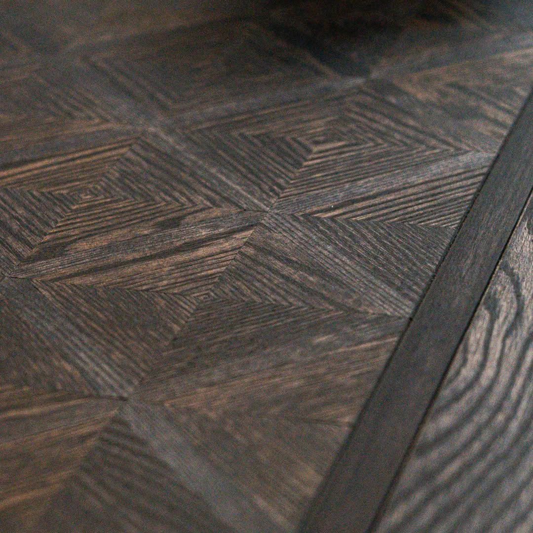 Detailed dark wooden herringbone patterned floor